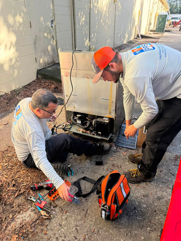 A closer look at the compressor and wiring during an R290 compressor replacement in the field.