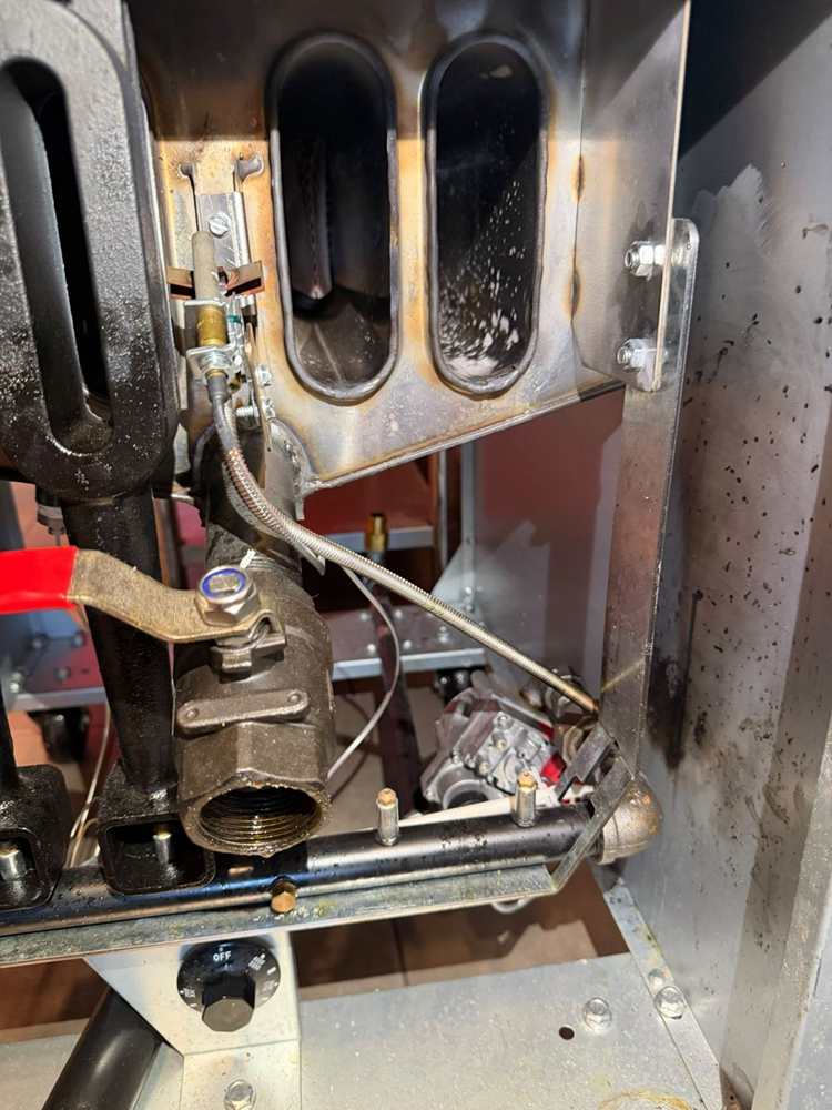Inspecting the burner tubes and manifold for scorching and heat damage near the union fitting closest to the gas valve.
