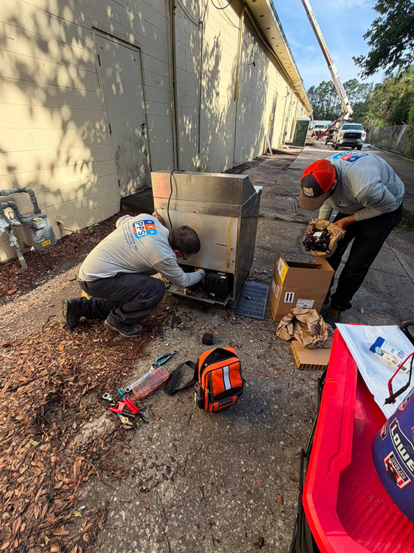 Our technicians performing an R290 compressor replacement outdoors for maximum safety and workspace.