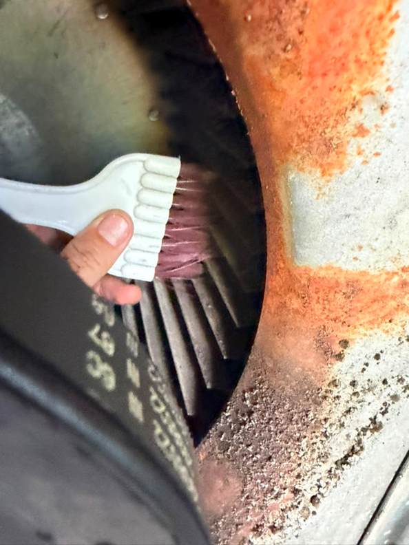 The blower wheel fins were caked in dirt and debris, choking off airflow before the repair.