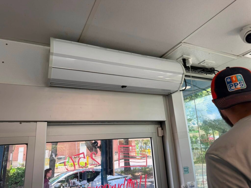 The completed air curtain installation above a busy walk-up window at a Jacksonville drink stand.