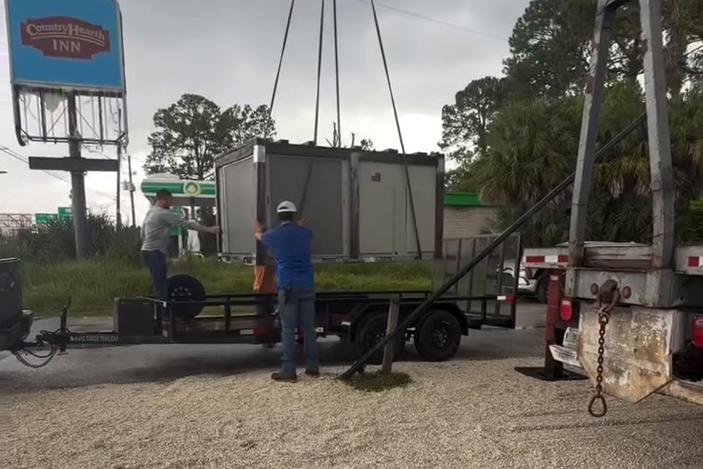 Our crew guides the unit into position during a commercial rooftop unit replacement.