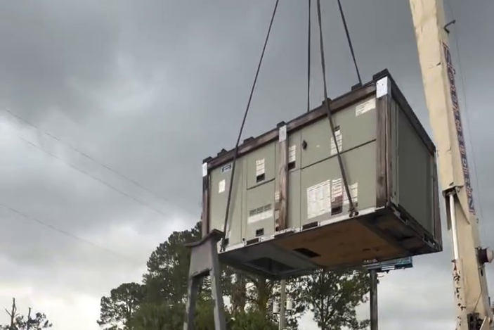 The unit is hoisted in one controlled lift, guided by our technicians.